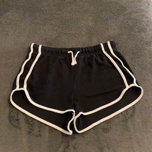 Black shorts with white detailing on sides and bottom edge